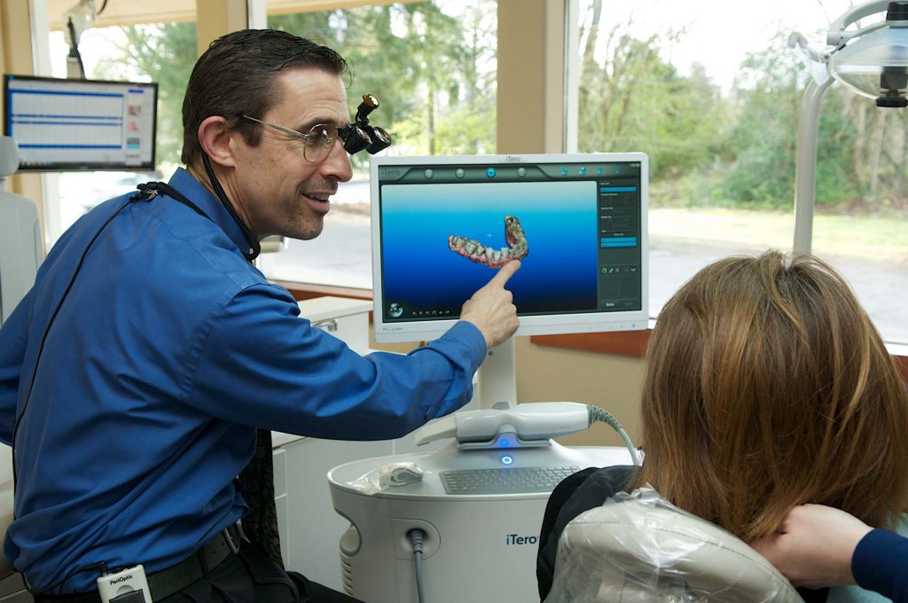 Dentist near me in Tumwater is working with his patient.