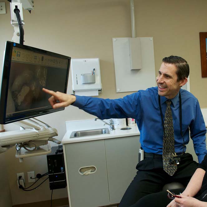 Dr. Gundersen in Tumwater helping a patient - Dentist Near Tumwater